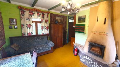 a living room with a couch and a fireplace at Czworaki Dworskie - Kiermusy in Kiermusy