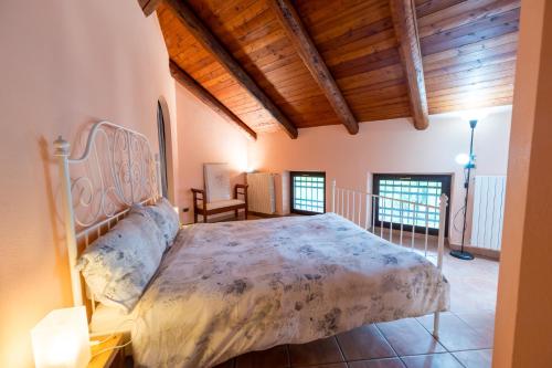 a bedroom with a bed in a room with wooden ceilings at Cascina Girba in Giaveno