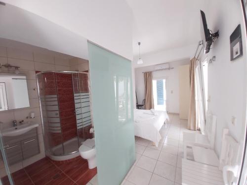 a bathroom with a shower and a toilet and a sink at Antonios 1 in Matala
