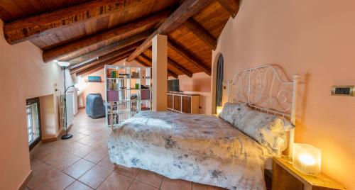 a bedroom with a bed in a room with wooden ceilings at Cascina Girba in Giaveno