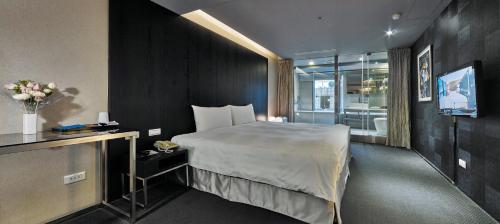 Habitación de hotel con cama y TV en 安庭台北商旅 en Taipéi