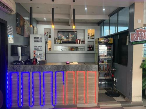 a bar in a restaurant with colored lights at THE GROOVE GUEST HOUSE in Lagos