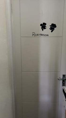 a white shower stall with a sign on the wall at 6 badger way in Hatfield