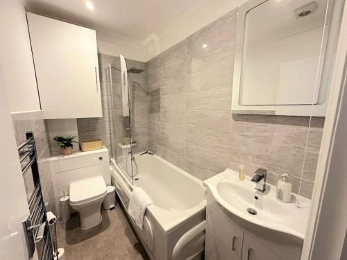 ein weißes Bad mit einem Waschbecken und einem WC in der Unterkunft Bournemouth Beach Apartment in Bournemouth