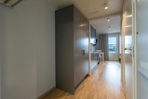 a hallway with a door to a room with a table at Uppsala Hotel Apartments in Uppsala