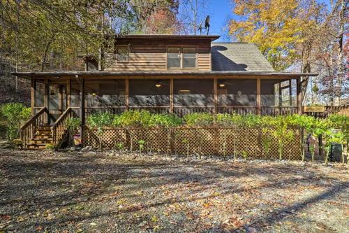 a large wooden house with a porch at Lakefront Cabin Bordering Nat Park with Hot Tub! cabin in Turtletown