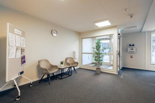 a room with chairs and a table and a window at Uppsala Hotel Apartments in Uppsala