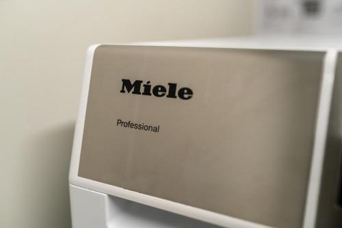 a close up of the side of a miele machine at Uppsala Hotel Apartments in Uppsala