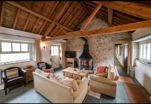 a living room filled with furniture and a fireplace at Haytor Rocks, Dartmoor escape in Bovey Tracey