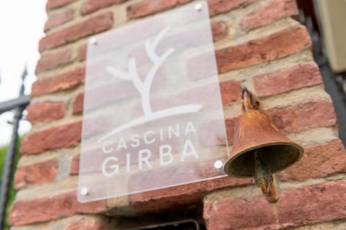 a rusted bell on the side of a brick building at Cascina Girba in Giaveno