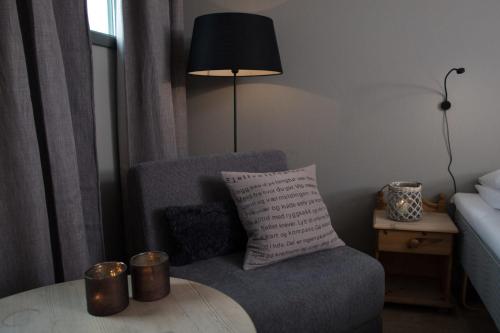 a living room with a chair and a table at Spidsbergseter Resort Rondane in Venabygd