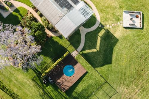 an overhead view of a garden with a blue ball at Heartwood Farm Byron Bay Luxury Farm Stay in Federal
