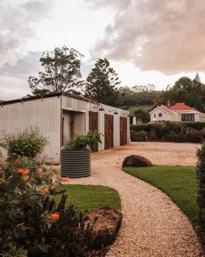 a house with a greenhouse in a garden at Heartwood Farm Byron Bay Luxury Farm Stay in Federal