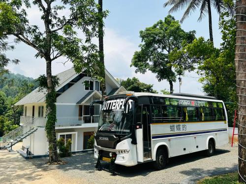 a bus parked in front of a house at Wild Brooke Guest House in Vythiri