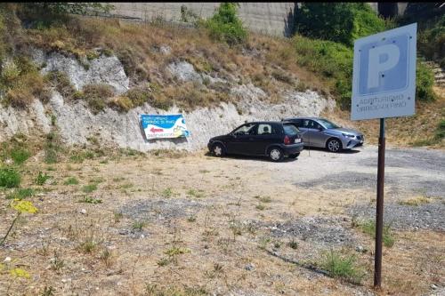 two cars parked on the side of a road at Agriturismo Orrido di Pino in Agerola