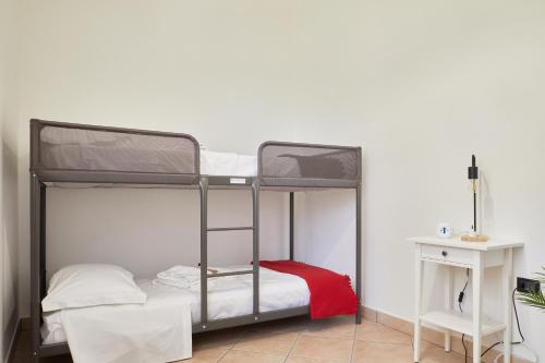 a bedroom with two bunk beds with a red pillow at Villa Belveder - Piscina, Parco e Vista by Host Hero in Castelraimondo