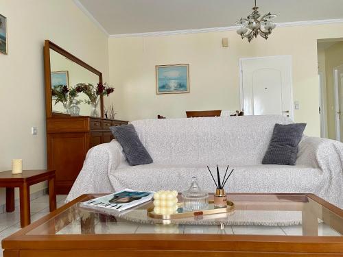 a living room with a couch and a table at Igoumenitsa Retiré Apartment in Igoumenitsa