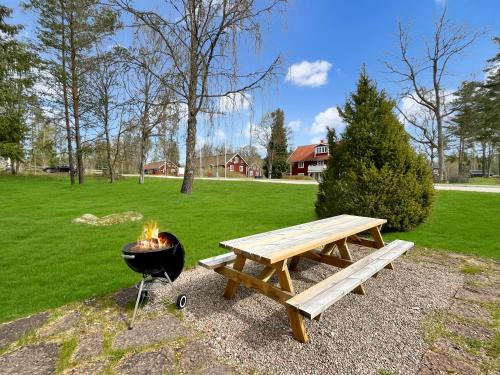 a picnic table and a grill next to a picnic bench at Accommodation For Construction Workers, Växjö Area 