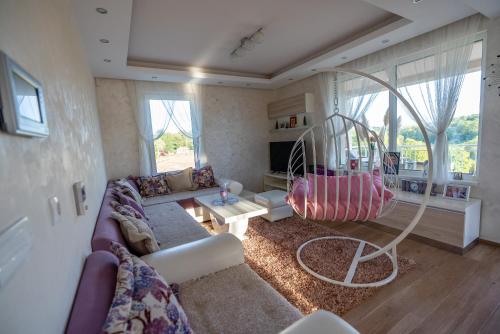 a living room with a couch and a large mirror at Vila Sanja in Valjevo