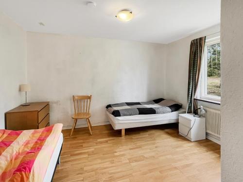 a bedroom with a bed and a chair and a window at Coparate Housing - Equipped Apartments For Work Crews in Bergdala