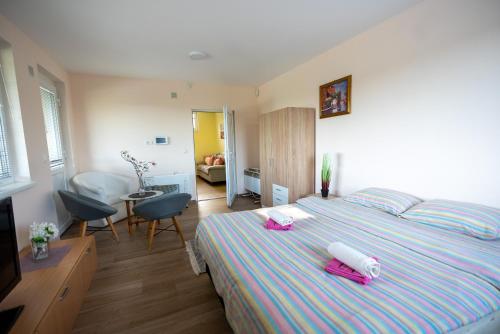 a bedroom with a bed with pink towels on it at Vila Sanja in Valjevo