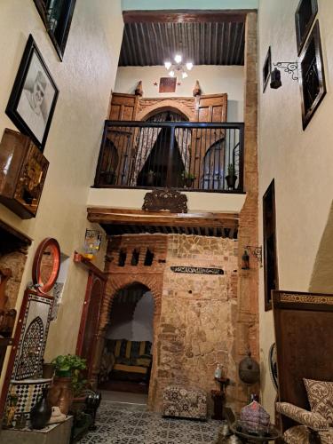 a staircase in a house with a stone fireplace at Dar Si hmed in Rabat