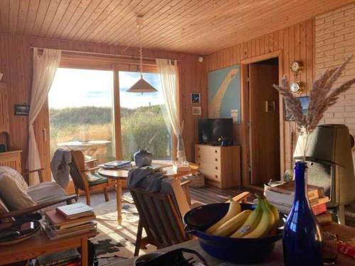 a living room with a couch and a table with bananas at Scenic Holiday Home In Skagen, in Skagen