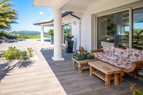 a patio with a couch and a coffee table at Maison Madalena With Pool close to ocean 