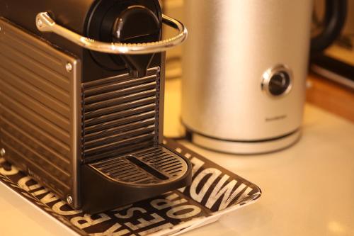 a toaster sitting on a counter next to a coffee pot at Boutique Barclay House London townhouse in London