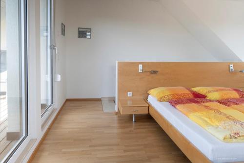 a bedroom with a bed and a large window at Panoramablick Dobl in Dobl-Zwaring
