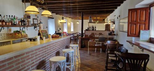 a restaurant with a bar and some stools at Albergue Laganares 