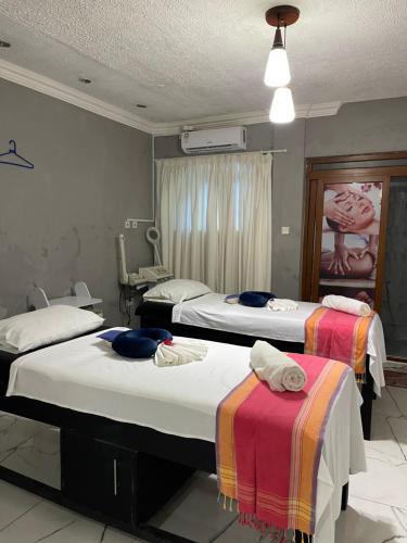 a room with two beds with towels on them at Sunrise Resort 1BR Apartment in Nyali