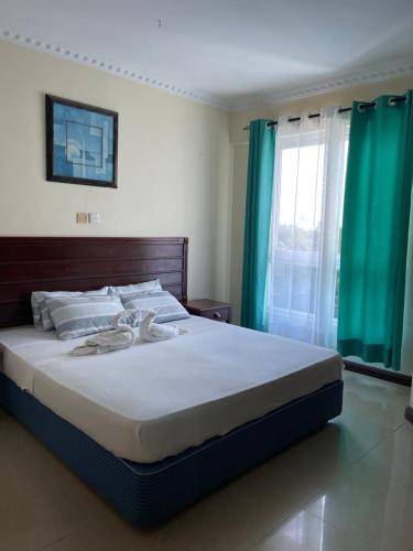 Ένα ή περισσότερα κρεβάτια σε δωμάτιο στο Sunrise Resort 1BR Apartment