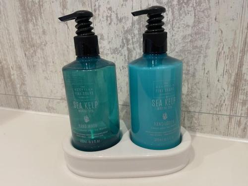 two bottles of detergent sitting on top of a sink at Tummel View Pitlochry in Pitlochry