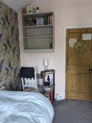 a bedroom with a bed and a wooden door at 6 Trinity grove Ella street HU5 3BB in Hull