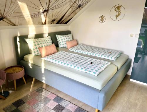 a couch with pillows on it in a room at Apartment Kirschti in Salzwedel