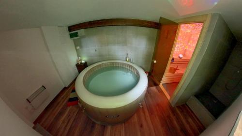 a bathroom with a large tub in the floor at TOBO house along the river Danube in Radvaň nad Dunajom