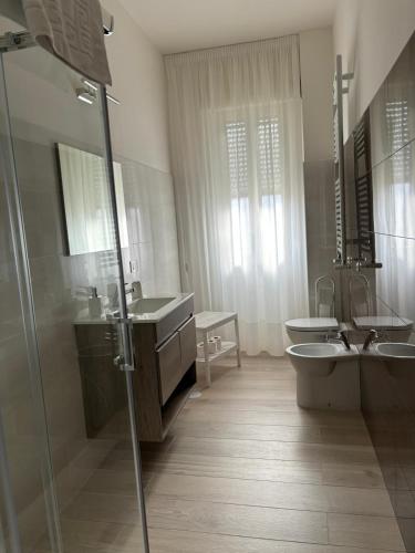 a bathroom with two sinks and a toilet and a shower at Casa Zelia in Ercolano
