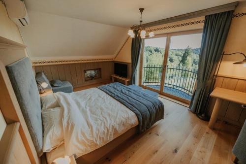a bedroom with a bed and a large window at Sweet Retreat in Trebelno