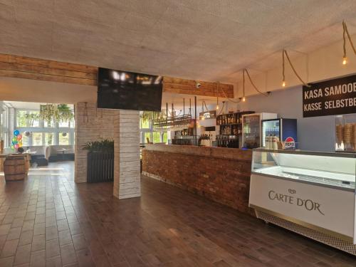 a restaurant with a counter and a coffee shop at OW Gromada Pod Bukami in Międzyzdroje