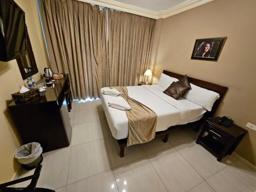 a hotel room with a bed and a window at Saint John Hotel in Madaba