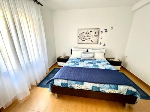 a bedroom with a bed with a blue comforter at Apartment Kontrada in Umag