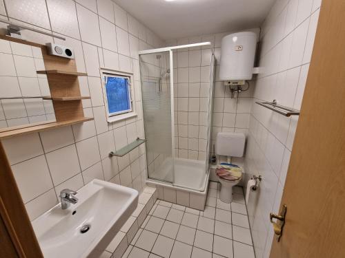 La salle de bains est pourvue d'un lavabo, d'une douche et de toilettes. dans l'établissement Ferienanlage "Am Sidowsee", à Himmelpfort