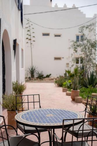 a blue table and chairs on a patio at Blue Kaouki Boutique Hotel in Sidi Kaouki