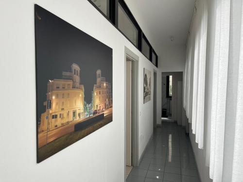 a hallway with a large picture hanging on the wall at Appartamento nel cuore di Forlì in Forlì