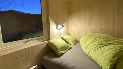 a small room with a bed and a window at Campinghytter ved Jotunheimen in Randsverk