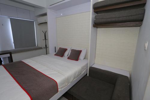 Krevet ili kreveti u jedinici u objektu Capital O 93914 Iconic Residence