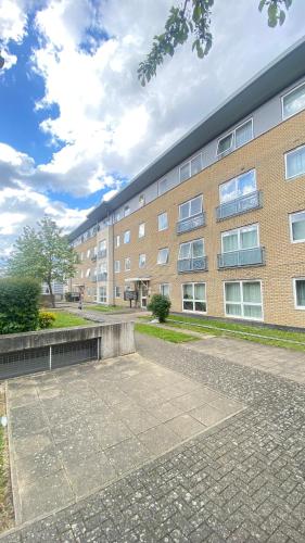 a large brick building with a bench in front of it at Nice room on the friendly flat in London