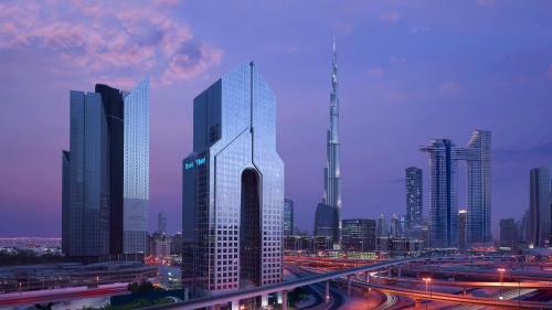 a tall building in the middle of a city at Dusit Thani Dubai in Dubai
