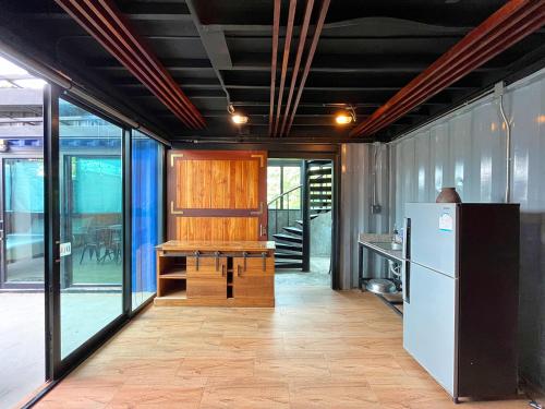 a kitchen with a refrigerator and a table at Hailin Resort Vangvieng in Vang Vieng